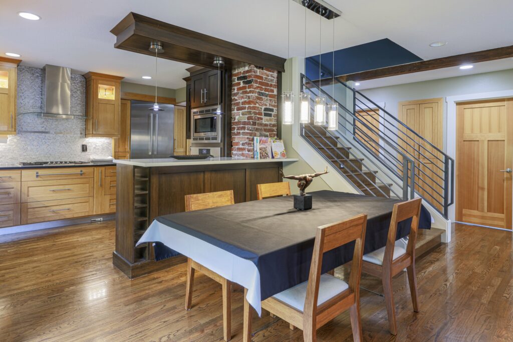Real estate interior shot of a formal dining area with designer lighting, captured by Artem Denisov Photography