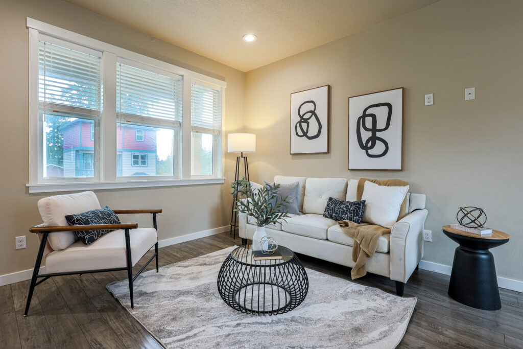 High-end residential photography of a spacious living room with natural lighting and professional staging