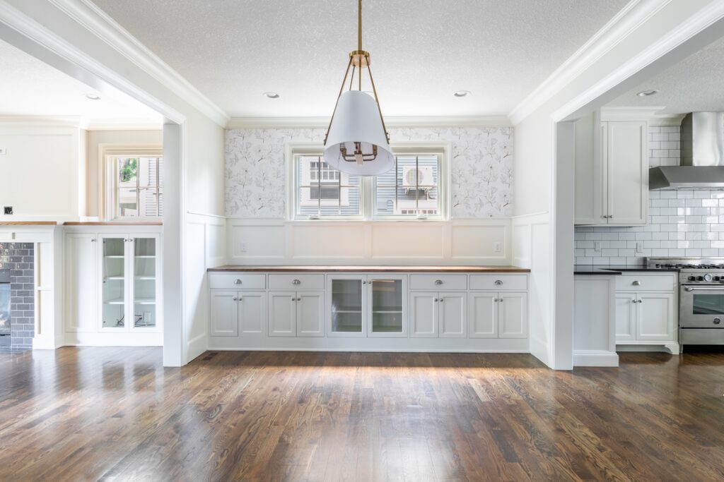 Real estate interior shot of a formal dining area with designer lighting, captured by Artem Denisov Photography