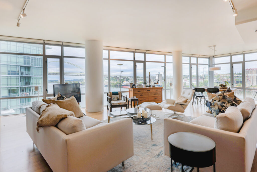 High-end residential photography of a spacious living room with natural lighting and professional staging