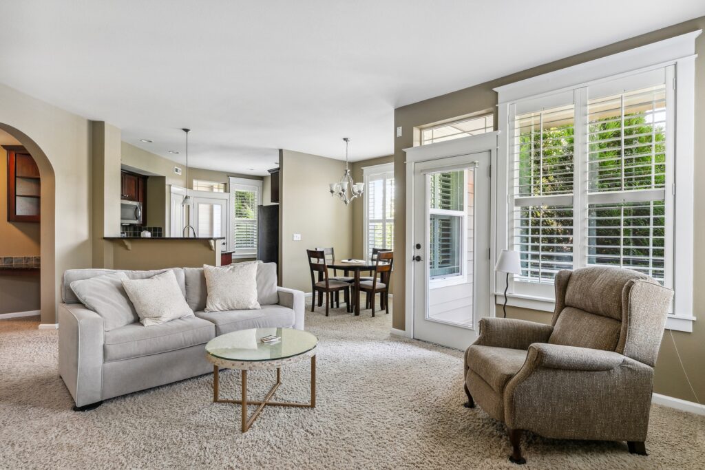 High-end residential photography of a spacious living room with natural lighting and professional staging