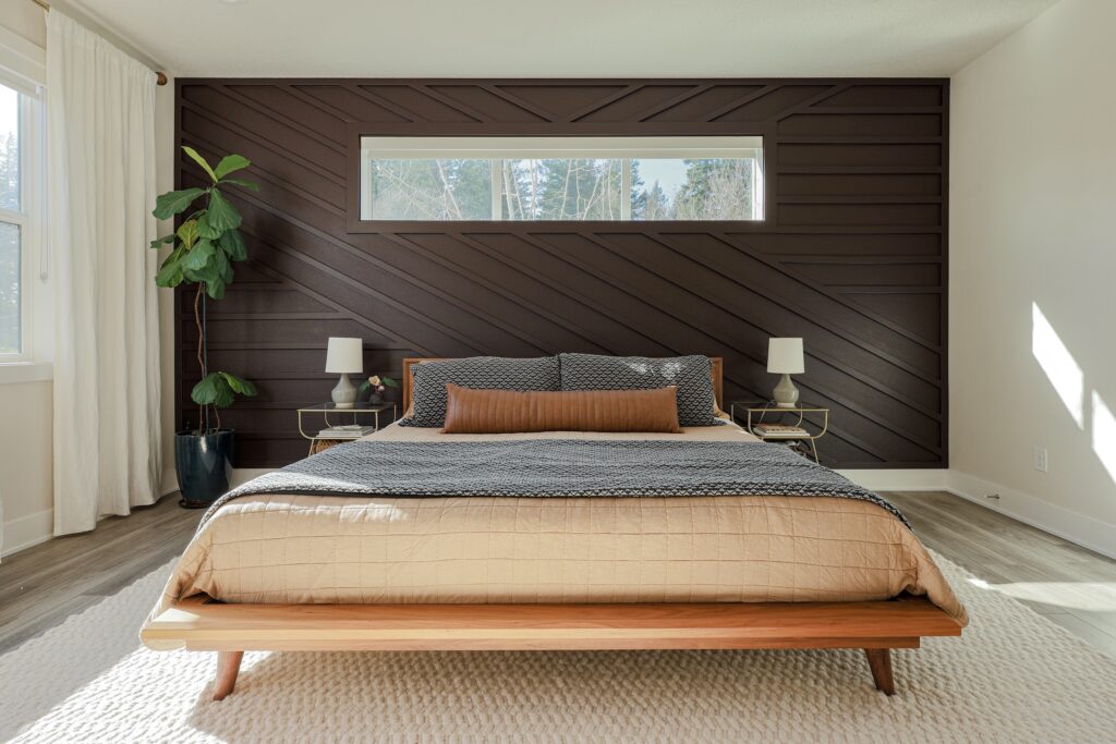 Master bedroom with custom dark wood geometric accent wall and mid-century modern bed frame
