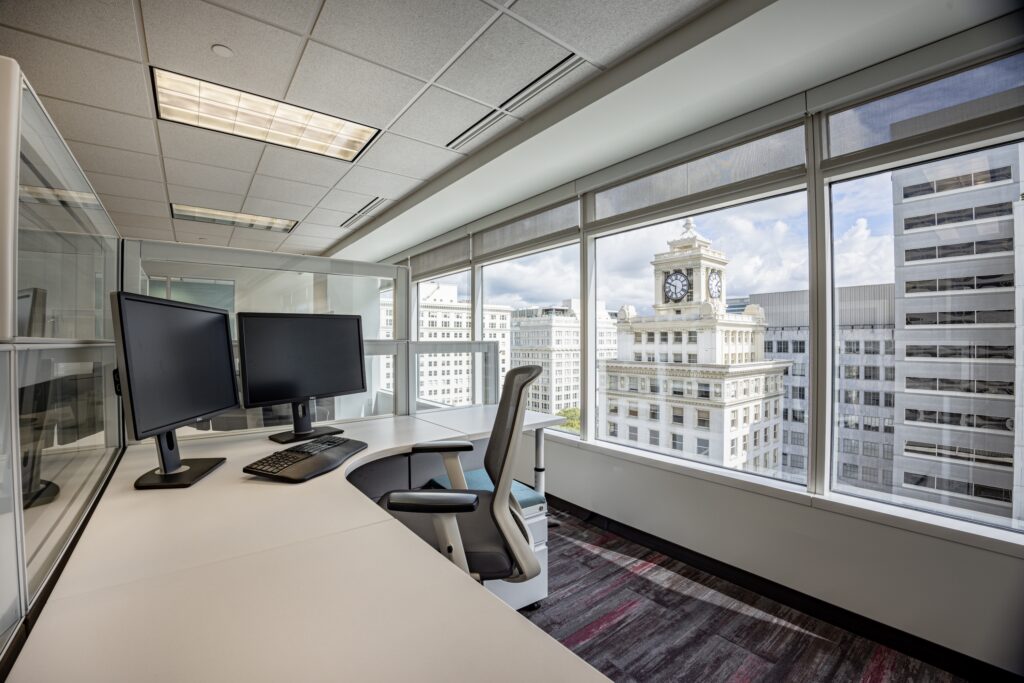 High-end co-working space interior photography with neon signage and modern office furniture at Fox Tower, Portland.